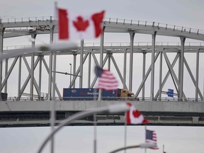 (FILES) In this file photo taken on March 16, 2020, a truck crosses the Bluewater Bridge border crossing between Sarnia, Ontario and Port Huron, Michigan.