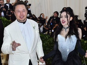 In this file photo taken on May 7, 2018 Elon Musk and Grimes arrive for the 2018 Met Gala, at the Metropolitan Museum of Art in New York.
