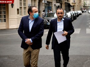 Stéphane Manigold (right), owner of four restaurants in Paris, arrives to give a press conference in Paris on May 22, 2020. Manigold brought a case against French insurer AXA. Last week, a Paris court ruled that the firm should pay Manigold two months' worth of revenue losses, which could set a global precedent.