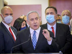 Israeli Prime Minister Benjamin Netanyahu, centre, delivers a statement before entering a courtroom at the district court of Jerusalem on May 24.