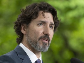 Prime Minister Justin Trudeau responds to a question from a member of the media on site during a daily news conference outside Rideau Cottage in Ottawa, Monday May 25, 2020.