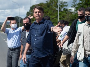 Brazilian President Jair Bolsonaro reacts during a demonstration in favor of his government amidst the coronavirus pandemic in front of Planalto Palace on May 24, 2020 in Brasilia, Brazil. Brazil has over 352,000 confirmed positive cases of Coronavirus and 22,291 deaths.