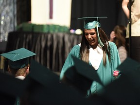 St. Joseph Catholic High School student Portia Ferrandes was enthusiastic as her peers congratulated her after she received her diploma and was returning to her seat during the school's convocation ceremony on Friday June 2, 2017 at Revolution Place in Grande Prairie, Alta.