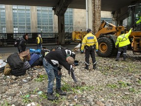 Jason reacts as city workers move to clear an encampment on Bay Street where he lived, in Toronto, Friday, May 15, 2020. The city is clearing homeless camps in the downtown area as part of their COVID-19 strategy.
