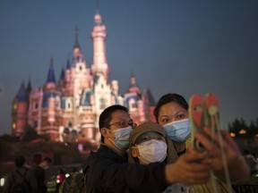 Tourists visit Shanghai Disneyland as it reopens after the pandemic lockdown.