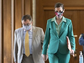 Quebec Deputy Premier and Public Security Minister Genevieve Guilbault, right, and Horacio Arruda, Quebec director of National Public Health walk to a news conference on the COVID-19 pandemic, Wednesday, May 20, 2020 at the legislature in Quebec City. Guilbault said today Quebec has 46,141 confirmed cases of COVID-19, an increase of 646, with 13,819 people recovered.