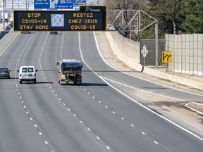 Traffic on Highway 401 in Toronto passes under a COVID-19 sign on Monday April 6, 2020. A new study says measures taken to fight the COVID-19 pandemic have resulted in greenhouse gas emissions being reduced worldwide by nearly one-fifth.