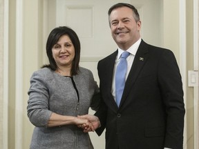 Alberta Premier Jason Kenney shakes hands with Adriana LaGrange, Minister of Education after being is sworn into office, in Edmonton on Tuesday April 30, 2019. Alberta's education minister has confirmed that students from kindergarten to Grade 12 won't be coming back for the rest of this school year due to the COVID-19 pandemic.