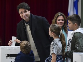 Prime Minister Justin Trudeau, left, votes in the 2019 election.