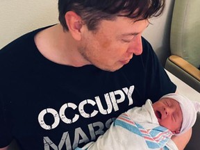Elon Musk pictured with his baby, his first child with Grimes and sixth child overall.