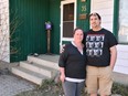 Homeowners Cora and Alec Dion pose by their home in Fort McMurray, Alta., on May 8, 2020. The Dions had about five feet of water in their basement as a result of recent flooding in downtown Fort McMurray. This marked the second time the couple faced evacuation from their home since the Horse River wild fire of May 3, 2016.