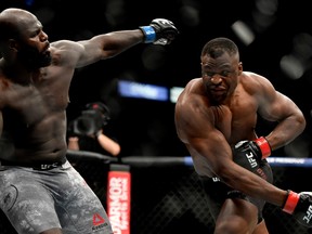 Francis Ngannou (R) of Cameroon misses a punch against Jair Rozenstruik of Suriname in their Heavyweight fight during UFC 249 at VyStar Veterans Memorial Arena on May 09, 2020 in Jacksonville, Florida