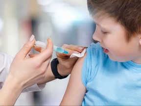 A child receives his vaccine from a pediatrician.