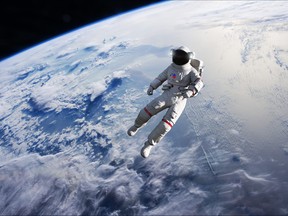 Astronaut conducting spacewalk on Earth orbit.