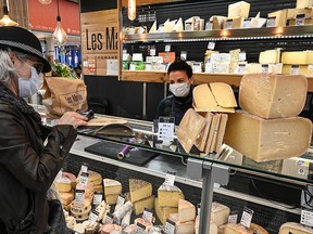 man buying French cheese in France