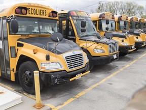 School buses are shown at a depot in Vaudreuil-Dorion, Que., west of Montreal, Sunday, May 10, 2020. Quebec schoolchildren will be entering a vastly changed environment this week when they head back to classrooms that have been closed since mid-March because of COVID-19.