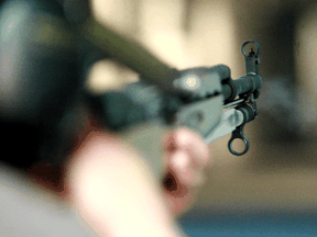 A shooter fires a round from his Russian SKS rifle at a Calgary firing range.