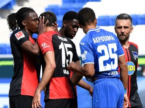 Hertha Berlin's Dedryck Boyata with Marko Grujic, as play resumes behind closed doors following the outbreak of the coronavirus disease.