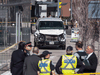 Police stand near a damaged van in Toronto after a number of pedestrians were fatally struck by a van driven on the sidewalk, April 23, 2018.