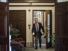 Alberta Premier Jason Kenney makes his way to the chamber as the Alberta Legislature sits through the weekend to pass a series of emergency bills, in Edmonton on Friday, March 20, 2020. Restaurants, barber shops and hair salons in Calgary and Brooks now have the official go-ahead to reopen their doors on Monday.