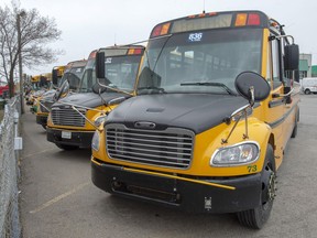 School busses are parked at a depot Friday May 8, 2020 in St. Eustache, Que. Quebec schoolchildren will be entering a vastly changed environment next week when they head back to classrooms that have been closed since mid-March because of COVID-19.