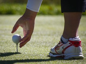 Canada's Brooke Henderson tees up her ball during second round action at the LPGA Canadian Open tournament in Priddis, Alta., Friday, Aug. 26, 2016. A golf course built to straddle the Canada-U.S. border during the prohibition era of the 1920s now finds itself out-of-bounds for Canadian members as COVID-19 border restrictions block access to the entrance on the American side.