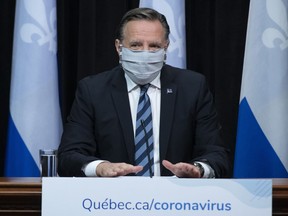 Quebec Premier Francois Legault arrives at a news conference on the COVID-19 pandemic wearing a mask, Tuesday, May 12, 2020 at the legislature in Quebec City.