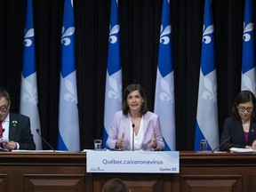 Quebec Deputy premier and Public Security Minister Genevieve Guilbault, centre, speaks to reporters at a news conference on the COVID-19 pandemic, Wednesday, May 6, 2020 at the legislature in Quebec City. Quebec Health Minister Danielle McCann, right, and Horacio Arruda, Quebec director of National Public Health sit by her side.