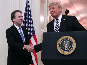 U.S. Supreme Court Justice Brett Kavanaugh shakes hands with President Donald Trump during Kavanaugh's swearing in at the White House on Oct. 8, 2018, in Washington, D.C. Kavanaugh was confirmed in the Senate 50-48 after a contentious process that included several women accusing him of sexual assault.