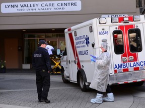 A paramedic (R) speaks with a firefighter (L) outside the Lynn Valley Care Centre, a seniors care home which housed a man who was the first in Canada to die after contracting novel coronavirus, in North Vancouver, British Columbia, Canada March 9, 2020.