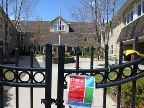 Signs and flowers are seen hanging outside the McKenzie Towne Continuing Care Centre during the COVID-19 pandemic. Friday, May 15, 2020.