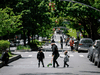 People walk on a street closed to vehicular traffic during a pilot program to provide more space for social distancing in the Queens borough of New York City.