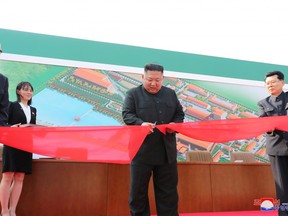 North Korean leader Kim Jong Un attends the completion of a fertiliser plant, together with his younger sister Kim Yo Jong, in a region north of the capital, Pyongyang, in this image released by North Korea's Korean Central News Agency (KCNA) on May 2, 2020. A