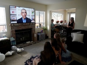 Torrey Pines High School graduating student Phoebe Seip (18, third from left) and family and friends watch former United States President Barack Obama deliver a virtual commencement address to millions of high school seniors who will miss graduation ceremonies due to the coronavirus disease (COVID-19) outbreak, while celebrating Phoebe's canceled prom night at home in San Diego, California, U.S., May 16, 2020.
