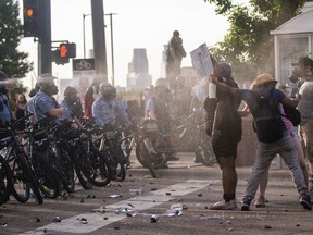 Protesters are shot with pepper spray as they confront police outside the Third Police Precinct on May 27, 2020 in Minneapolis, Minnesota.