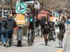 Pedestrians walk along a sidewalk on April 28, 2020 in Montreal.