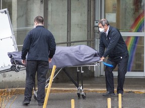 Funeral home workers remove a body from the Centre d'hebergement Ste-Dorothee, Monday April 13, 2020 in Laval, Que.