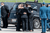 Family and friends embrace during a repatriation ceremony at CFB Trenton for the six Canadian Forces personnel killed in a helicopter crash off the coast of Greece, May 6, 2020.