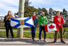 People watch as hearses depart for a repatriation ceremony at CFB Trenton for the six Canadian Forces personnel killed in a helicopter crash off the coast of Greece, May 6, 2020.