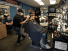 Darren Ewanyk gets a haircut from Nick Moustafa at Mickey’s Barber Shop as some businesses began to reopen as part of the first phase of Alberta’s COVID-19 relaunch, in Edmonton on May 14, 2020.
