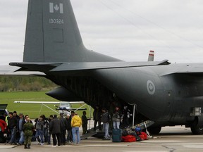 People from the Kashechewan first nation community arrive on a Canadian military transport plane in Stratford, Ont., Monday, April 28. 2008 after flooding in Northern Ontario forced the evacuation of the residents. Residents of a Northern Ontario First Nation threatened by spring flood waters are facing more complex and some fear-inducing options for escape this year, thanks to the COVID-19 pandemic.