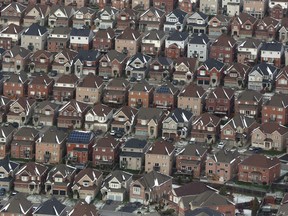 An aerial view of houses in Oshawa, Ont., is seen from a Canadian forces Hercules on Saturday, Nov. 11, 2017.