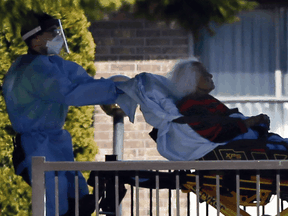 Patients are transported at the Orchard Villa Retirement Residence on April 22, 2020 following a deadly COVID-19 outbreak.