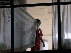 A worker closes the curtains at the Lynn Valley Care Centre in North Vancouver.