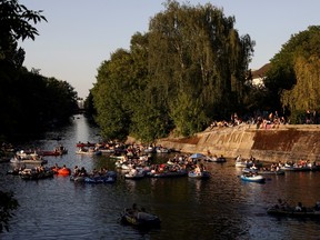 People enjoy sun on boats, on the Landwehrkanal, amid the spread of the coronavirus disease (COVID-19), in Berlin, Germany, May 9, 2020.