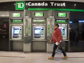 FINANCE—A woman uses Toronto's PATH system as she walks past the TD Canada Trust ATM machines, Thursday January 18, 2018.