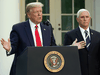 U.S. President Donald Trump speaks as Vice President Mike Pence listens during a news conference on COVID-19 in the Rose Garden of the White House, April 27, 2020.