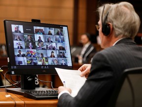 Canadian Members of Parliament, displayed on a computer monitor, attend the first virtual meeting of the special committee on the COVID-19 pandemic, as efforts continue to slow the spread of the coronavirus disease (COVID-19), on Parliament Hill in Ottawa, Ontario, Canada April 28, 2020.