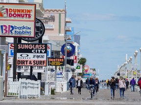 Visitors walk along the boardwalk on the first day coronavirus disease (COVID-19) restrictions were eased in Ocean City, Maryland, U.S., May 9, 2020.