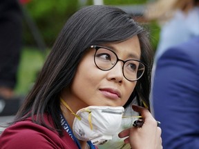 CBS News White House correspondent Weijia Jiang pulls back her protective face mask after asking U.S. President Donald Trump why he was saying "Don't ask me, ask China that question" to her after she asked him why he considers coronavirus testing a "global competition" during a coronavirus disease (COVID-19) outbreak response briefing at the White House in Washington, U.S., May 11, 2020.